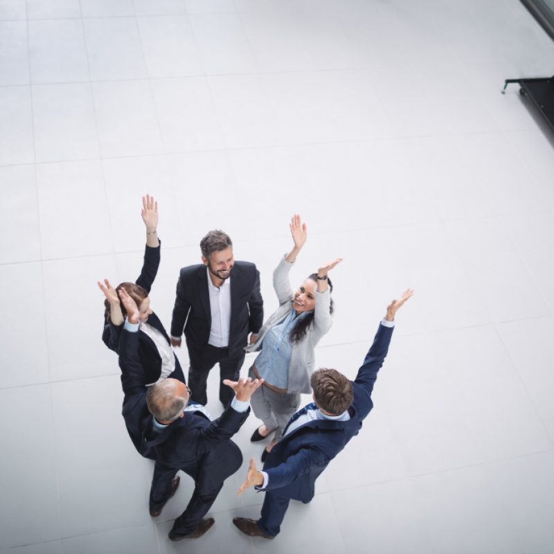 businesspeople-standing-with-hands-raised